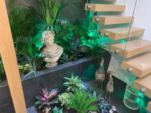 a indoor garden with a statue and plants at Apartamentos San Fernando 24 in Córdoba