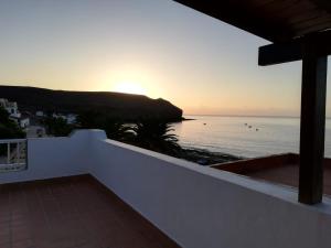 a view of the ocean at sunset from a house at LA ORILLA BEACH HOUSE in Lajita