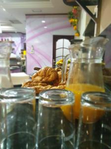 a table with glasses of orange juice and a plate of food at Las Nieves in Granada