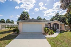 a house with a garage in a yard at Van Ness Poolhome - Lake access 2mi in Hernando