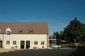 a large white building with a brown roof at The Final Furlong, Bruton in Bruton