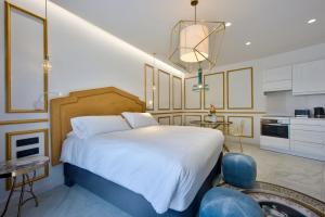 a bedroom with a large bed and a kitchen at HOLM Boutique & SPA - IK Collection in St. Julianʼs