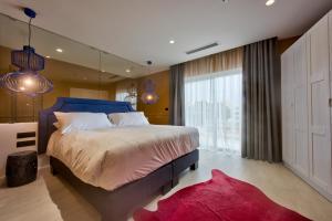 a bedroom with a large bed and a large window at HOLM Boutique & SPA - IK Collection in St. Julianʼs