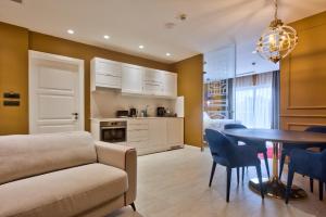 a living room with a couch and a table with chairs at HOLM Boutique & SPA - IK Collection in St. Julianʼs