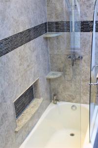 a bathroom with a shower and a bath tub at Master Bedroom-Private Bath, Washington DC in Washington