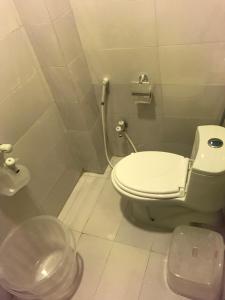 a small bathroom with a toilet and a sink at "Service Apartments Karachi" Ocean View 2 Bed Room Apt in Karachi +15 photos