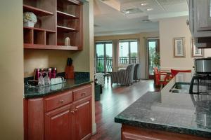 a kitchen with a counter and a living room at Ocean Inn & Suites in Saint Simons Island