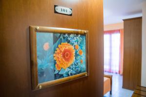 a picture of a painting of a flower on a door at Yiannis Apartments in Ioannina