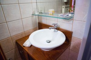 a bathroom with a white sink and a mirror at Yiannis Apartments in Ioannina