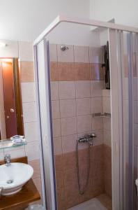 a bathroom with a shower and a sink at Yiannis Apartments in Ioannina