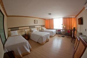 Postel nebo postele na pokoji v ubytování Hotel Oro Inn