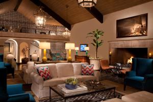 a living room with a couch and a fireplace at Kona Kai Resort & Spa, a Noble House Resort in San Diego