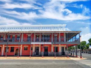 a red building on the corner of a street at Commercial Motel in Hay