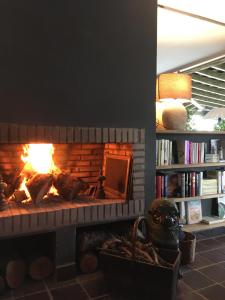 a brick fireplace with a fire in it at La Lagartija Adults Only in Ajo