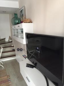 a large computer monitor sitting on a white desk at ETNICAN in San Bartolomé de Tirajana