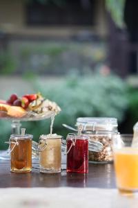 a table with jars of honey and a plate of food at Villa Balthazar in Búzios