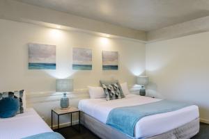 a hotel room with two beds and two lamps at Fairways Resort in Rosebud