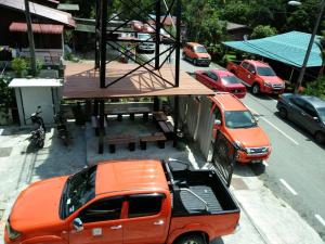 an orange truck parked on the side of a street at A105 Homestay in Sungkai
