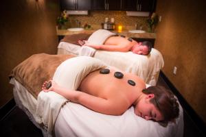 two naked women laying on beds in a room at Elevation Hotel & Spa in Mount Crested Butte