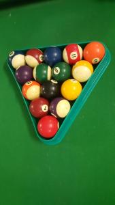 a tray of billiard balls on a green table at Phong Nha Love Homestay in Phong Nha