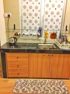 a kitchen with a sink and a counter top at Cameron Highland Guesthouse in Tanah Rata