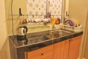 a kitchen counter top with a sink and a counter top at Cameron Highland Guesthouse in Tanah Rata