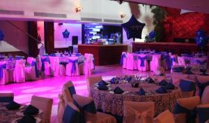 a room filled with tables and chairs with purple lighting at Grand Royal Tampico in Tampico +70 photos