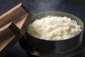 a metal bowl of rice and a pair of chopsticks at Niigata Daiichi Hotel in Niigata