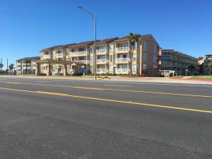 an empty street in front of a apartment building at The Victorian Condo/Hotel in Galveston