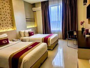 Postel nebo postele na pokoji v ubytování Grand Parama Hotel + 31 fotografií