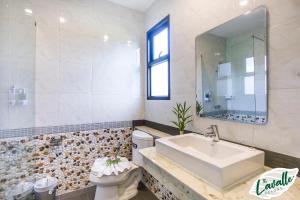 a bathroom with a sink and a toilet and a mirror at The La Valle'e Resort in Khao Lak +32 photos
