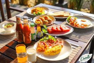 a table topped with plates of food and drinks at The La Valle'e Resort in Khao Lak
