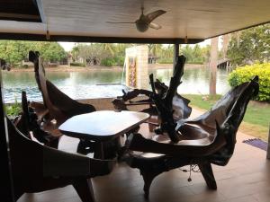 duas cadeiras e uma mesa com vista para um rio em Rock Garden E28 4 bedroom Pool villa em Mae Pim