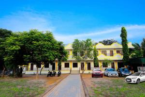 a building with cars parked in front of it at Rani Residency in Puducherry