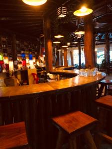 a bar in a restaurant with wooden tables and chairs at M'pay Bay Guesthouse in Koh Rong Sanloem +39 photos