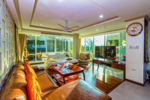 Karon View Apartments في شاطئ كارون: غرفة معيشة مع أريكة وطاولة