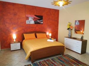 a bedroom with a bed and two night stands with lamps at B&B Salerno in Sarno