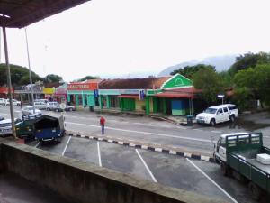 a street with cars parked in a parking lot at langkawi homestay murah kawasan bandar in Kuah
