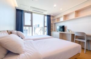 Postel nebo postele na pokoji v ubytování Hi Residences