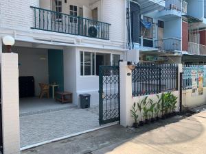a gate to a building with a balcony at Float's House in Chiang Mai
