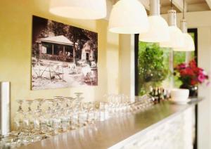 a bar with wine glasses and a picture on the wall at Berghotel Wintersberg in Bad Ems