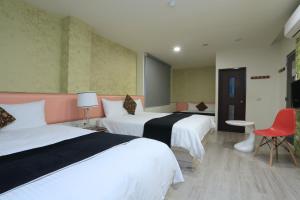 Postel nebo postele na pokoji v ubytování Guo Chen Hotel