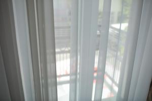 a close up of a window with white curtains at Hotel Elements in Novi Pazar