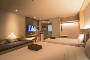 Ein Bett oder Betten in einem Zimmer der Unterkunft Baan Karon Resort