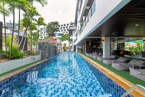 a swimming pool in the middle of a building at Baramee Resortel in Patong Beach