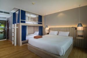 Ein Bett oder Betten in einem Zimmer der Unterkunft Baan Karon Resort