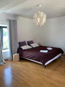 a bedroom with a large bed in a room at La Ferme de Maryse in Les Mesneux