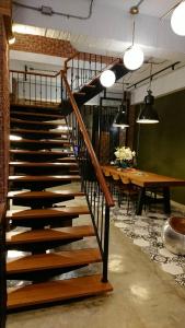 a wooden staircase in a room with a table at Mr. Buster B&B in Hualien City