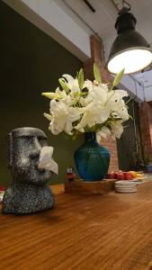 a vase with white flowers sitting on a table at Mr. Buster B&B in Hualien City
