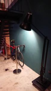 a bike on a table next to a lamp at Mr. Buster B&B in Hualien City